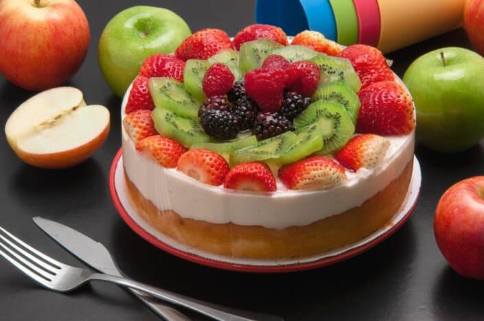 round cake with assorted fruits on top