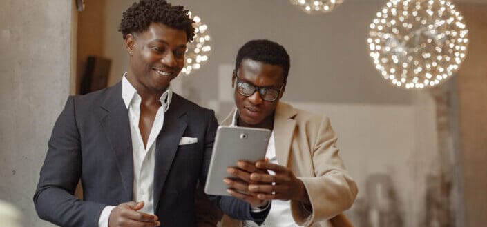 happy businessmen browsing tablet