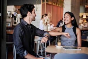 Nice guy and cool girl doing a fun elbow bump. - Main