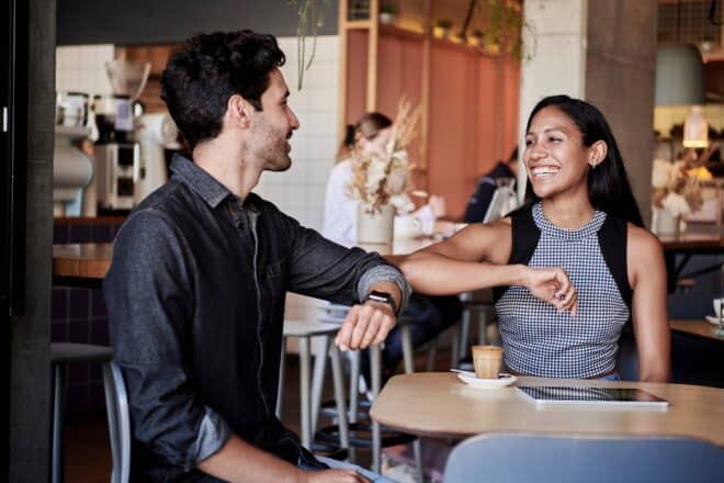 Man and woman having an elbow bump. - Clean pick up lines