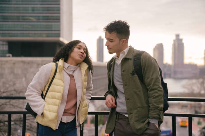 Hispanic couple talking on urban street