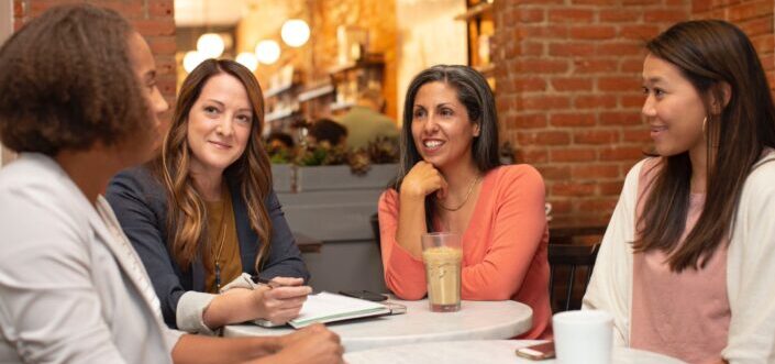 Four women having a group discussion