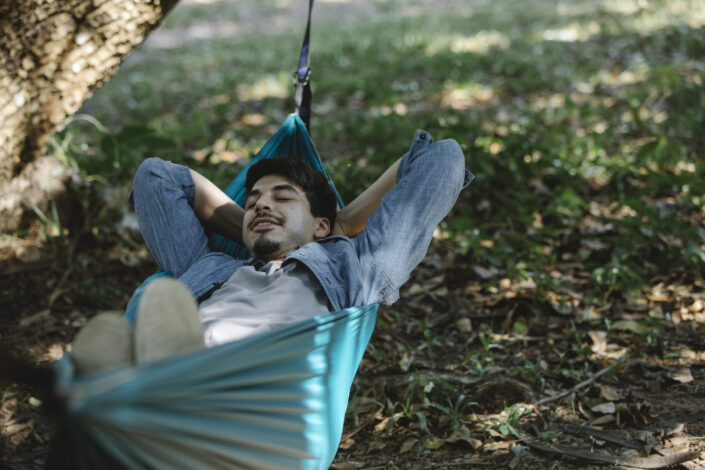 relaxed bearded man resting in hammock