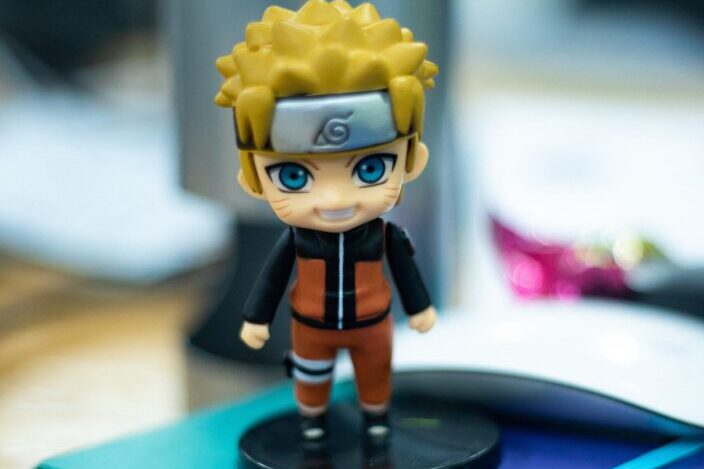 naruto figurine on top of notebook