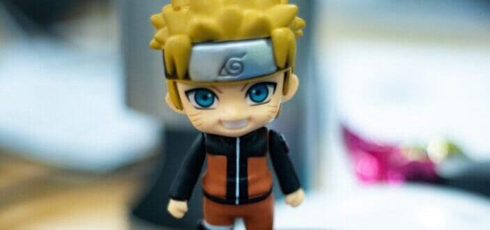 A naruto miniature on top of a notebook.