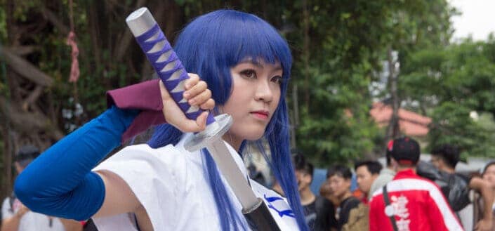 cosplayer woman holding sword