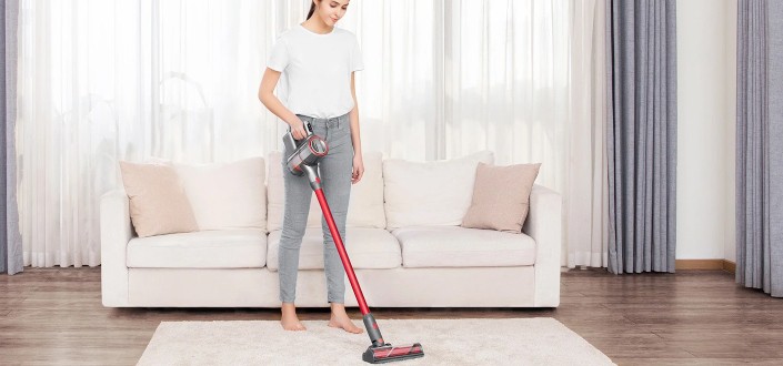 a woman vacuuming her carpet