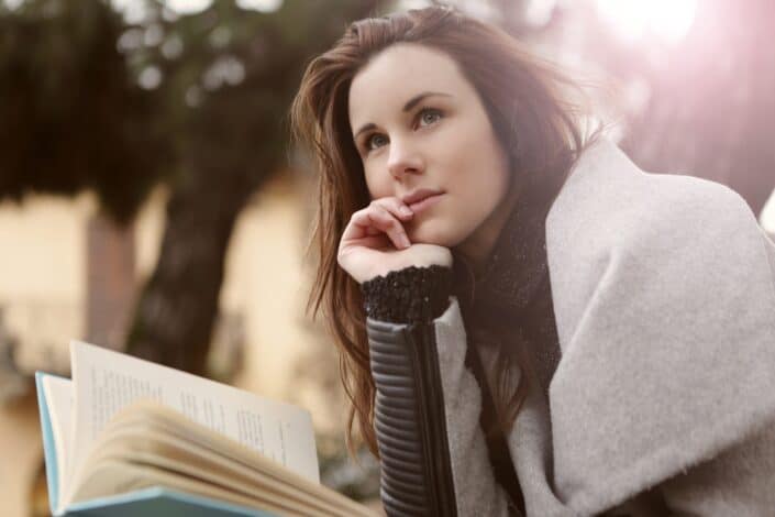 Woman paused from reading and thinking something