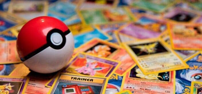 Pokeball Toy on a bunch of Pokemon Cards