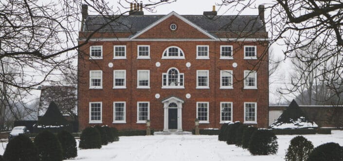 A huge house in a winter setting.