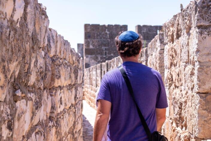 Man Walking along The Old City Of Jerusalem