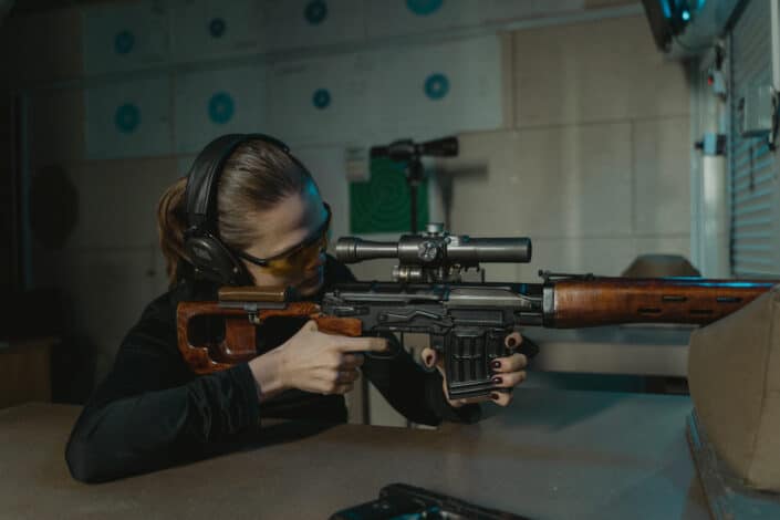 A woman shooting with a BB gun.