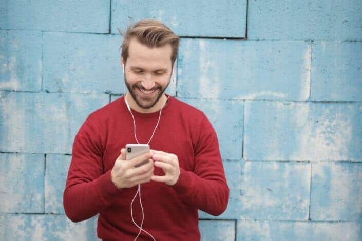 cheerful man watching videos on his phone