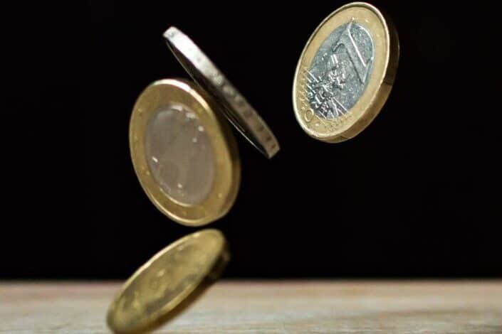 coins on brown wood