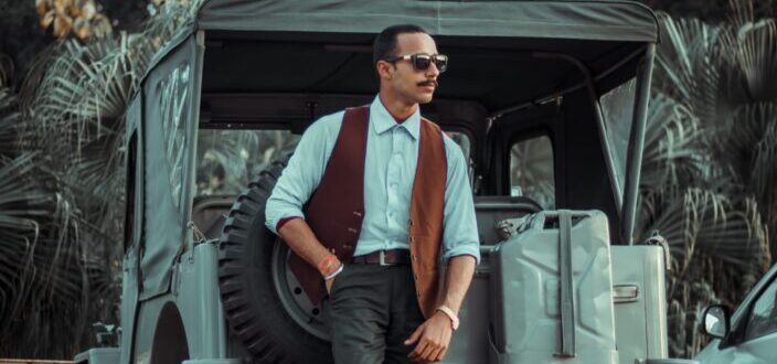 man leaning on his truck in daytime