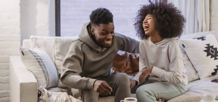Couple laughing together.