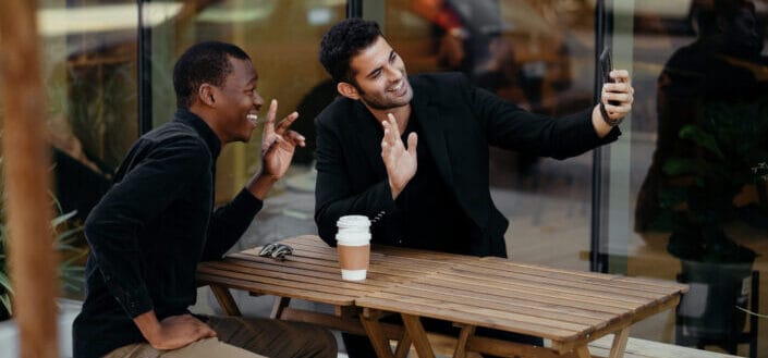 friends doing selfies at coffee shop 