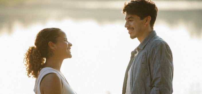 happy couple looking at each other at lakeside