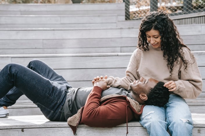 multiethnic couple holding hands on steps