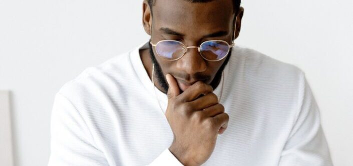  A man in eyeglasses on a deep thought