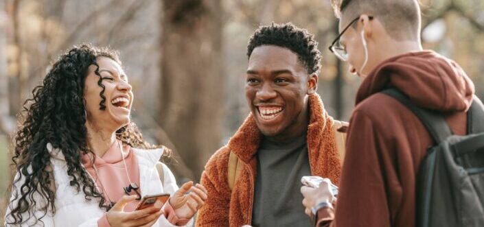 Three young adults bonding with a good laugh