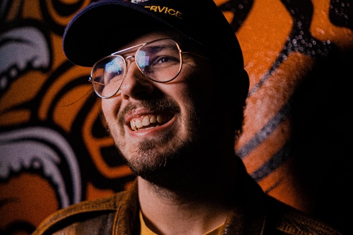 smiling man wearing cap and glasses