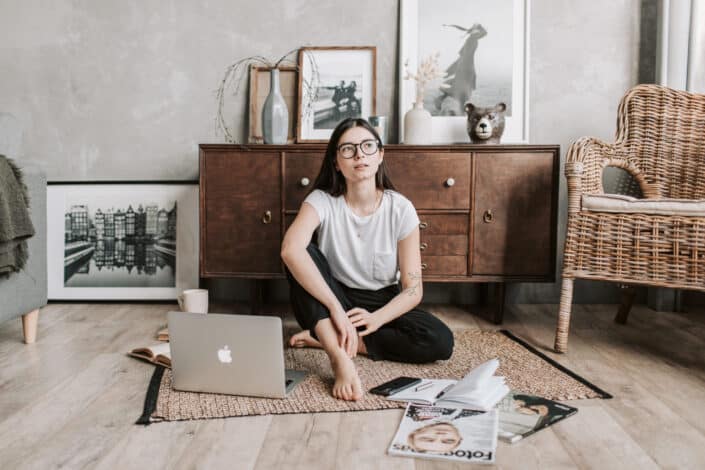 Woman reminiscing while sitting on the floor