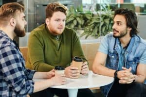 Three guys talking during their coffee break