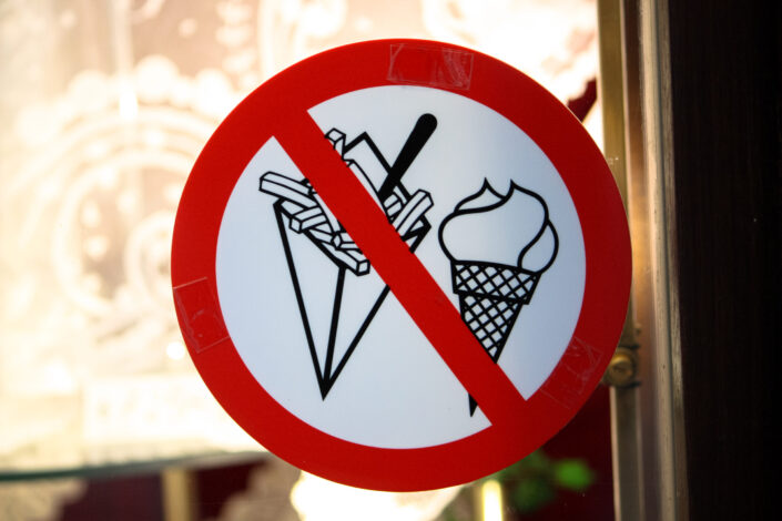 a signage indicating that french fries and ice cream is prohibited