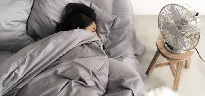 A woman sleeping comfortably in her bed.