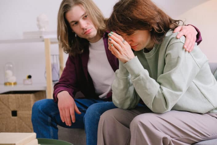 sad woman being comforted by the man