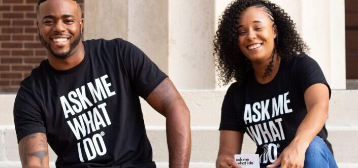 Man and woman wearing black statement shirts.