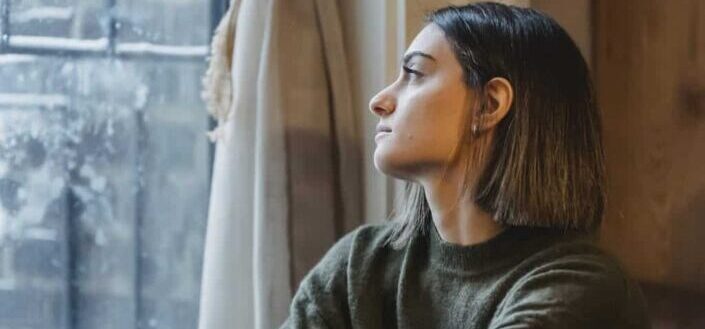 Woman staring outside by the window