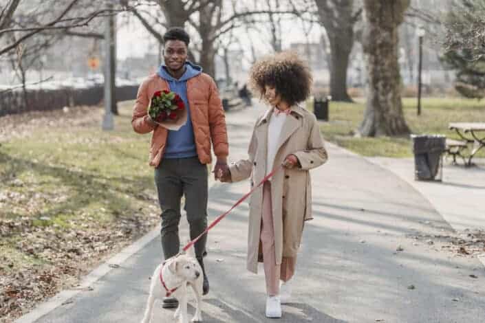 Couple walking outside with their pet