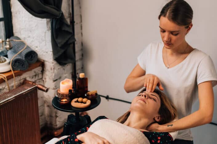 Therapist doing a head massage to customer