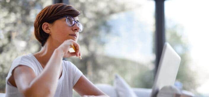 Woman in eyeglasses thinking