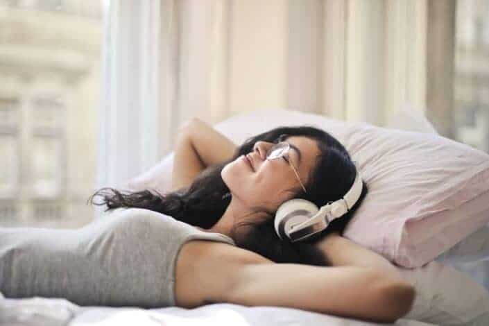 Woman in Gray Tank Top Lying on Bed