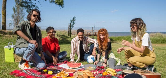 friends sitting while having a picnic