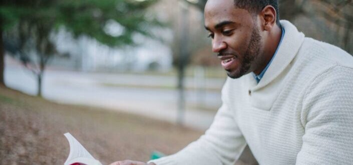 Man reading a book in a park