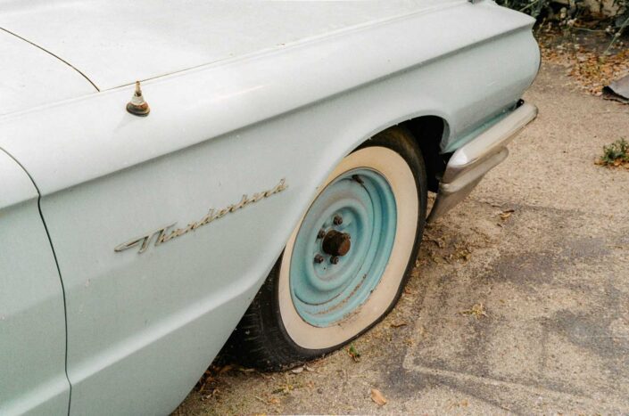 A vintage car with a flat tire