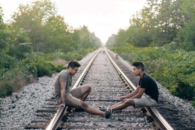 two guys sitting on the rail track - weird questions to ask