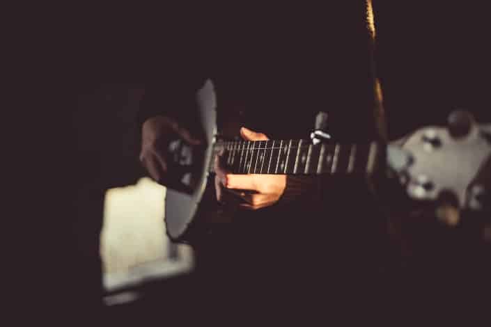 A ukulele being played in the dark