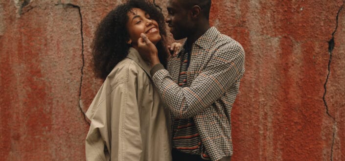 A teenage couple flirting with each other.