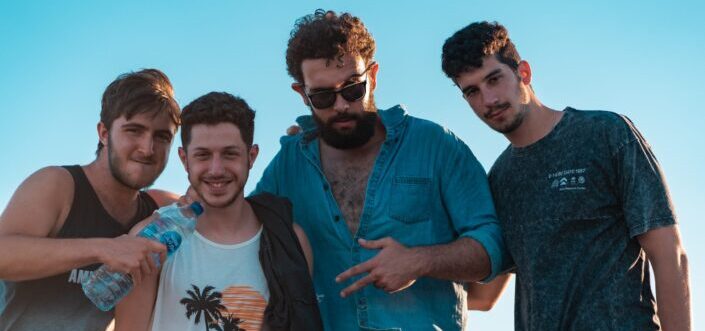 Four men on a casual attire posing for a picture