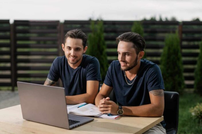 two men looking at laptop