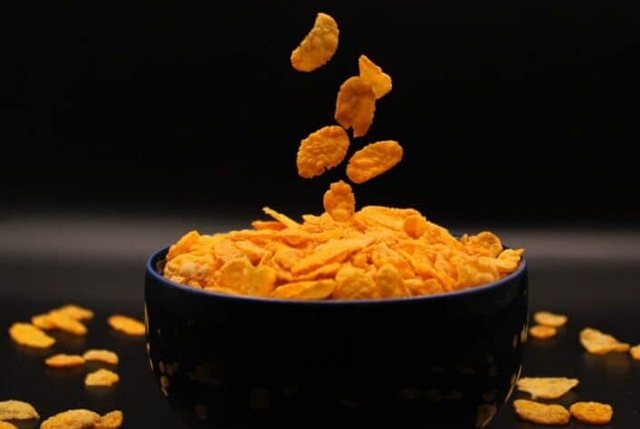 falling cornflakes on a bowl
