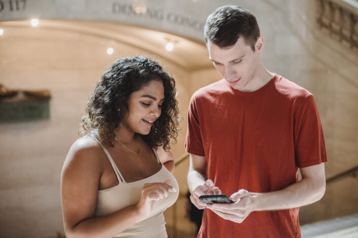 Man and a woman looking at something on a phone