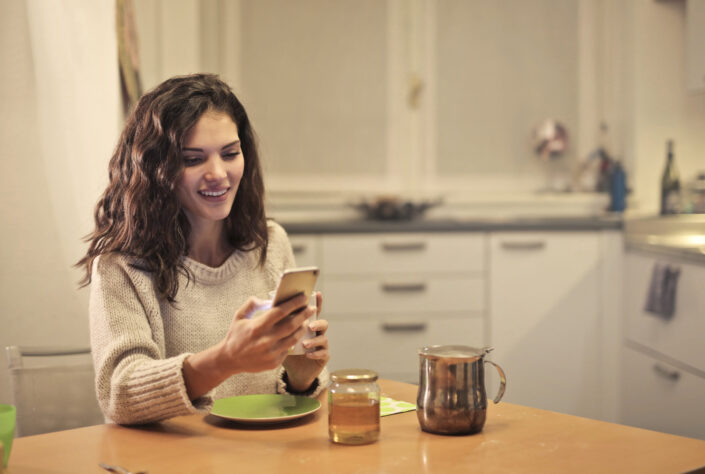 Woman smiling over something on her phone