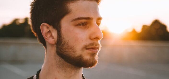 man wearing black shirt and necklace