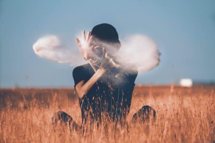 Man throwing sand on air